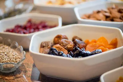 a table topped with bowls of different types of food at Hotel Garni Doris in Castelrotto