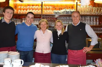 a group of people standing in front of a counter at Hotel Garni Doris in Castelrotto