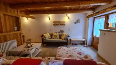 a living room with a couch and a table at Baita Pra Petina Pale di San Martino in Siror