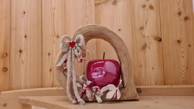 a wooden mirror with a red object on a table at Baita Pra Petina Pale di San Martino in Siror