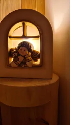 a small television with a picture of a girl on it at Baita Pra Petina Pale di San Martino in Siror