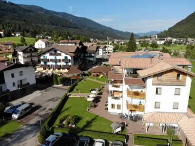 an aerial view of a village with houses and cars at Residence Nele in Ziano di Fiemme