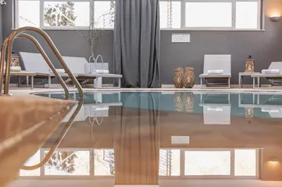 a room with a pool with vases on the floor at Hotel Nele in Ziano di Fiemme