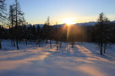 a winter sunrise in the mountains with snow on the ground at Berggasthof Pension Pfitscher in Unsere Liebe Frau im Walde