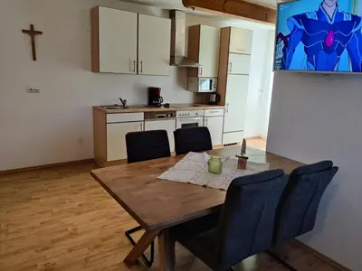 a kitchen with a wooden table and chairs in a room at Residence Klementhof 4 in Fiumes