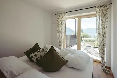 a bedroom with a bed and a large window at Villa Bea in Caines
