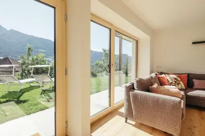 a living room with a couch and a large window at Villa Bea in Caines