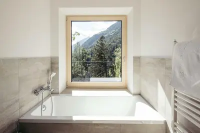 a bath tub in a bathroom with a window at Villa Bea in Caines