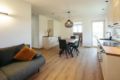 a living room and kitchen with a couch and a table at Villa Bea in Caines