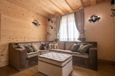 a living room with a couch and a window at Cortina Deluxe Chalet R&R in Zuel