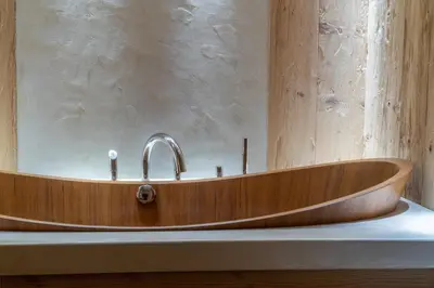 a wooden bath tub sitting on a counter in a bathroom at Cortina Deluxe Chalet R&R in Zuel