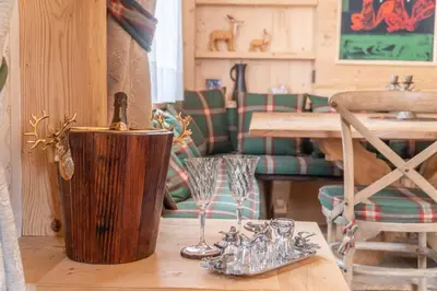a table with glasses and a wine bottle on it at Cortina Deluxe Chalet R&R in Zuel
