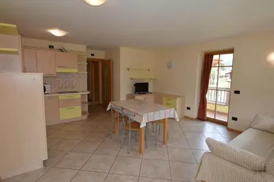 a kitchen with a table and chairs in a room at Casa Fior del Soreie in Pozza di Fassa