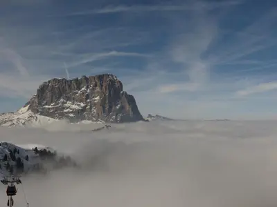 a mountain above a layer of fog in the mountains at Chalet Aldian Dolomites in Selva di Val Gardena