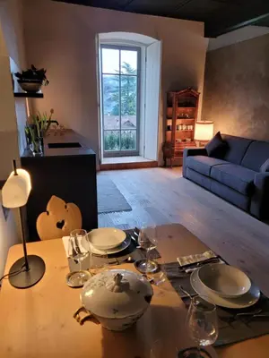 a living room with a table with plates on it at Ansitz Montani Eppan in Appiano sulla Strada del Vino