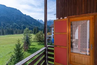 a window of a house with a view of a field at Casa Francesco in Falcade