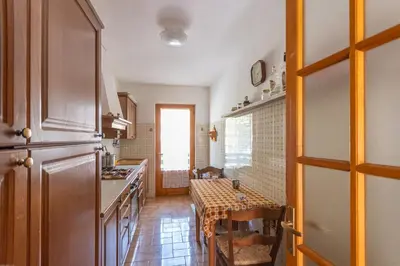 a kitchen with a table and a dining room at Casa Francesco in Falcade
