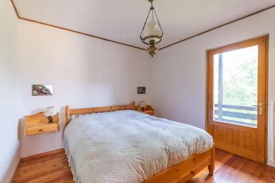 a bedroom with a bed and a window at Casa Francesco in Falcade