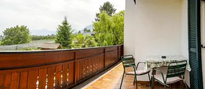 a patio with a table and chairs on a balcony at Ferienwohungen Gamper in Tirolo