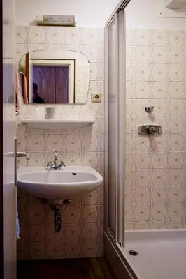 a bathroom with a sink and a mirror at Ferienwohungen Gamper in Tirolo