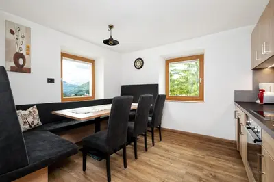 a kitchen and dining room with a table and chairs at Apartments San Vigilio in San Vigilio Di Marebbe