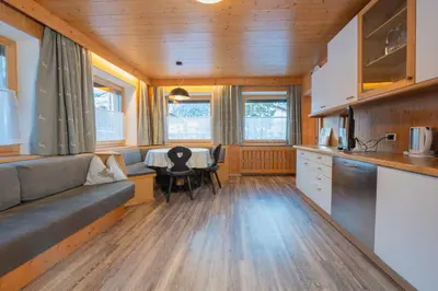 a kitchen and living room with a couch and a table at Apartments San Vigilio in San Vigilio Di Marebbe