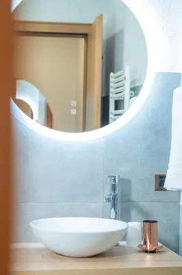a bathroom with a white sink and a mirror at Apartments San Vigilio in San Vigilio Di Marebbe