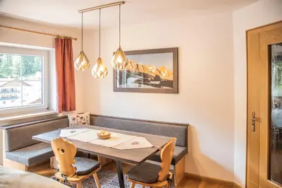 a dining room with a table and chairs at La Odles in Selva di Val Gardena