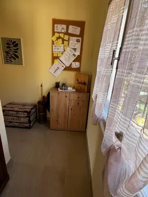 a room with a window and a wooden cabinet at Casa Vacanze Natura in Mendola