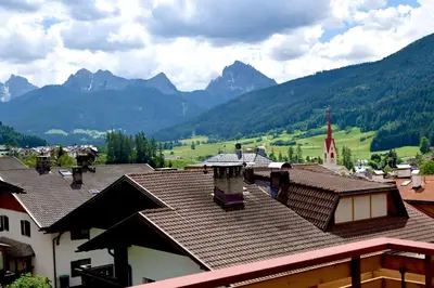 a view of a village with mountains in the background at Aurturist Monguelfo Roulette in Monguelfo