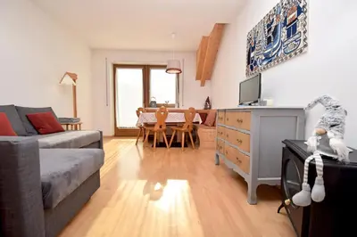 a living room with a couch and a dining room at Aurturist Monguelfo Roulette in Monguelfo