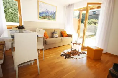 a living room with a couch and a table at Aurturist Villabassa in Villabassa