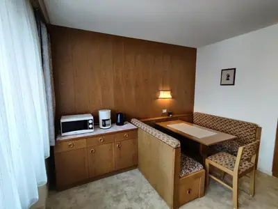 a small room with a table and a microwave at Lärchenheim in Obereggen