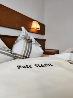a white bed with the words little marmite on it at Lärchenheim in Obereggen