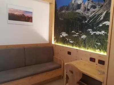 a living room with a couch and a table at Hotel L'Ideale in Moena
