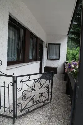 a balcony with a wrought iron railing and windows at APPARTAMENTO VALENTINI in Campitello di Fassa