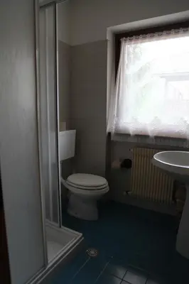 a bathroom with a toilet and a sink at APPARTAMENTO VALENTINI in Campitello di Fassa
