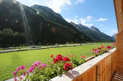 a view from the balcony of a house with flowers at Ferienwohnungen Unterangerhof in Quinzo