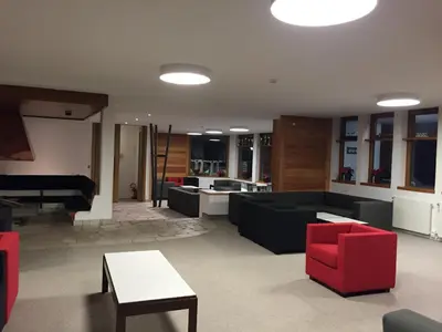 a living room with couches and a pool table at Appartamento Alpe di Siusi in Alpe di Siusi