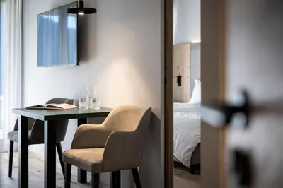a room with a table and chairs and a bedroom at Mühlwaldhof Appartement in Fiumes