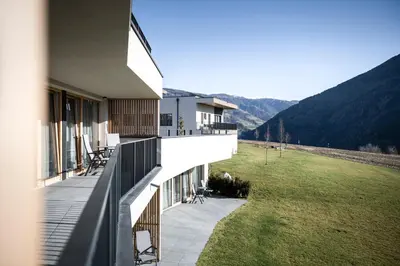 a balcony of a house with a view of a field at Mühlwaldhof Appartement in Fiumes