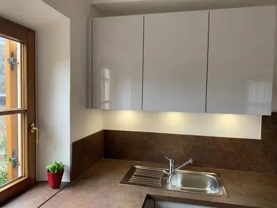 a kitchen with a sink and white cabinets at Appartment Valentin in Chiusa