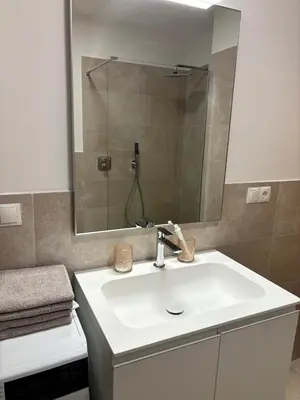 a bathroom with a white sink and a mirror at Appartment Valentin in Chiusa
