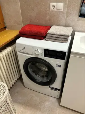 a washing machine with a red towel on top of it at Appartment Valentin in Chiusa