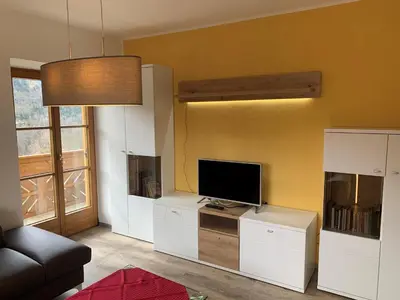 a living room with a flat screen tv on a cabinet at Appartment Valentin in Chiusa