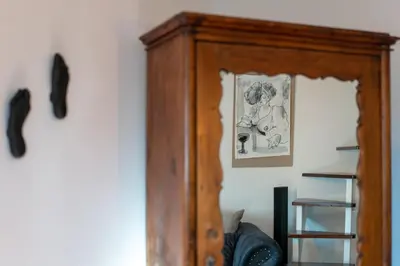 a wooden cabinet in a room with a picture on the wall at Il Florino Maia in Merano