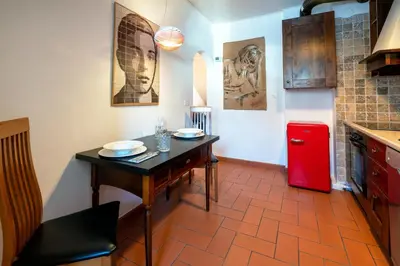 a kitchen with a table and a red refrigerator at Il Florino Maia in Merano