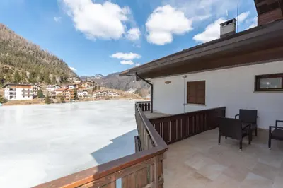 a view from the balcony of a house with a frozen lake at Miralago in Alleghe