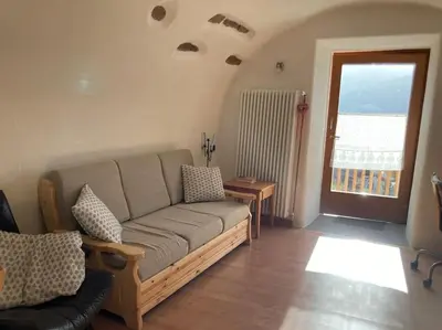 a wooden door with a window and a vase of flowers at CASA DIAF appartamento incantevole Carano Ville di Fiemme in Carano
