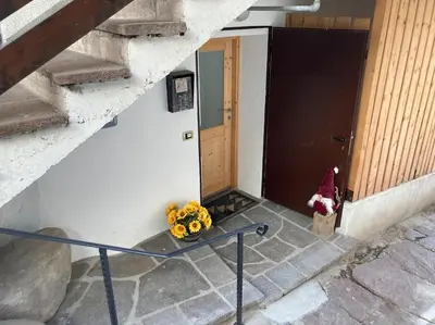 a hallway with a stone archway in a house at CASA DIAF appartamento incantevole Carano Ville di Fiemme in Carano